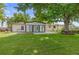 Large green backyard features big shade tree and covered patio at 16839 E Amherst E Ave, Aurora, CO 80013