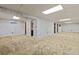 Spacious basement with textured carpet flooring, bright lighting, and access to other rooms at 16839 E Amherst E Ave, Aurora, CO 80013