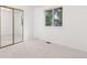 This bedroom has a large window with a view of the outside and closet with sliding mirror doors at 16839 E Amherst E Ave, Aurora, CO 80013