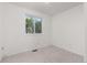 A view of the bedroom containing a large window that overlooks the yard, walls are white and flooring is carpeted at 16839 E Amherst E Ave, Aurora, CO 80013