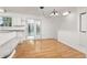 Bright kitchen and dining area with white cabinets, granite countertops, and hardwood floors at 16839 E Amherst E Ave, Aurora, CO 80013