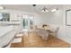 Bright dining area featuring white cabinets, granite countertops, and hardwood floors at 16839 E Amherst E Ave, Aurora, CO 80013