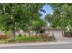 Charming single-story home featuring a well-manicured lawn, mature trees, and a welcoming facade at 16839 E Amherst E Ave, Aurora, CO 80013