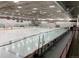 Indoor ice rink featuring a smooth, shiny surface, surrounded by protective netting and seating at 16839 E Amherst E Ave, Aurora, CO 80013