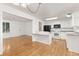 Kitchen and living space with bright white cabinets, granite countertops, and hardwood floors at 16839 E Amherst E Ave, Aurora, CO 80013