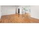 Open-concept space featuring hardwood floors leading to a well-lit kitchen with white cabinetry at 16839 E Amherst E Ave, Aurora, CO 80013