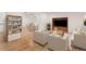 Bright and airy living room with hardwood floors, neutral tones, and a custom built-in entertainment center at 16839 E Amherst E Ave, Aurora, CO 80013