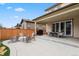 The backyard features a concrete patio, a grill, string lights, and lots of seating at 11008 Hayloft St, Parker, CO 80134