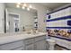 This bathroom features a large mirror, lots of counter space, and colorful decor at 11008 Hayloft St, Parker, CO 80134