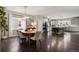 Open concept dining area with hardwood floors, modern lighting, and kitchen view at 11008 Hayloft St, Parker, CO 80134