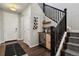 Inviting entryway features a wine cooler and rack, complemented by a staircase with black railings at 11008 Hayloft St, Parker, CO 80134