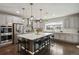 Spacious kitchen featuring a large island with pendant lights and stainless steel appliances at 11008 Hayloft St, Parker, CO 80134