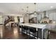 Gourmet kitchen with stainless steel appliances, quartz countertops, and a large center island with seating at 11008 Hayloft St, Parker, CO 80134