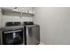 Laundry room features sleek, silver, front-loading LG washer and dryer with countertop above at 11008 Hayloft St, Parker, CO 80134