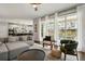 Bright living room with floor-to-ceiling windows, neutral tones, and a glimpse into the modern kitchen at 11008 Hayloft St, Parker, CO 80134
