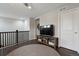 Upstairs loft area featuring railing, large screen TV, and convenient access to bedrooms at 11008 Hayloft St, Parker, CO 80134