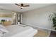 This spacious main bedroom features hardwood floors, a ceiling fan, and neutral paint at 11008 Hayloft St, Parker, CO 80134
