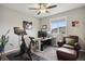 This office features a desk, chair, stationary bike, and lots of natural light at 11008 Hayloft St, Parker, CO 80134