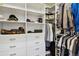 This walk-in closet features many shelves and hanging spots for all of your clothes at 11008 Hayloft St, Parker, CO 80134