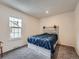 Bedroom with light gray platform bed and gray carpeting at 14222 E Hawaii Cir # F, Aurora, CO 80012