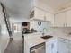 Modern kitchen featuring white cabinets, stainless steel appliances, and a view to the living room at 14222 E Hawaii Cir # F, Aurora, CO 80012