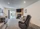 Comfortable living room featuring a stone fireplace, a sliding glass door and neutral color palette at 14222 E Hawaii Cir # F, Aurora, CO 80012