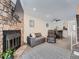 Living room with stone fireplace, gray couch, and recliner at 14222 E Hawaii Cir # F, Aurora, CO 80012