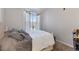 This cozy bedroom offers neutral walls, plush carpet, and a bright window at 7440 S Blackhawk St # 4-105, Englewood, CO 80112