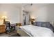 Bright bedroom featuring a desk space, a cozy bed and an open doorway at 7440 S Blackhawk St # 4-105, Englewood, CO 80112