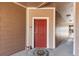 Welcoming entryway with a red door and a cute decorative welcome mat at 7440 S Blackhawk St # 4-105, Englewood, CO 80112