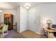 Apartment entryway featuring double doors, neutral walls, and beige carpet at 7440 S Blackhawk St # 4-105, Englewood, CO 80112