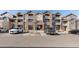 Attractive multi-story condo building featuring stone accents, balconies, and convenient parking at 7440 S Blackhawk St # 4-105, Englewood, CO 80112
