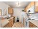 Galley kitchen shows stainless appliances, neutral counters, and overhead lighting at 7440 S Blackhawk St # 4-105, Englewood, CO 80112