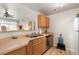 Bright kitchen features stainless steel dishwasher, neutral countertops, and wood cabinetry at 7440 S Blackhawk St # 4-105, Englewood, CO 80112