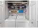 Laundry closet has storage shelves above the side by side washer and dryer at 7440 S Blackhawk St # 4-105, Englewood, CO 80112