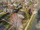 Aerial view of a two-story home with a second-floor balcony, surrounded by trees and lush greenery at 1100 Hudson St, Denver, CO 80220