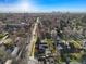 A neighborhood aerial view of a charming home featuring lush greenery and stunning skyline views at 1100 Hudson St, Denver, CO 80220