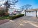 View of the backyard with a patio, garage, and lovely landscaping at 1100 Hudson St, Denver, CO 80220