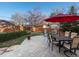 Backyard patio with a red umbrella and plenty of seating at 1100 Hudson St, Denver, CO 80220