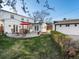A backyard features a brick home with a patio and outdoor seating, ideal for outdoor relaxation at 1100 Hudson St, Denver, CO 80220