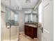 Bathroom features granite countertop, dark wood vanity, tile floor and glass enclosed shower at 1100 Hudson St, Denver, CO 80220