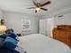 Bright bedroom featuring a large bed, wood floors, and ample closet space at 1100 Hudson St, Denver, CO 80220