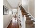 Bright hallway with hardwood floors and staircase leading to the upper level at 1100 Hudson St, Denver, CO 80220
