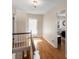 Hallway with hardwood floors and white trim, leading to bedroom at 1100 Hudson St, Denver, CO 80220