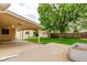 Beautiful backyard featuring a large shade tree, shed, and covered patio area at 3780 E 117Th Ave, Thornton, CO 80233