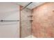 Bathroom shower enclosure featuring earth tone tile and glass doors at 3780 E 117Th Ave, Thornton, CO 80233