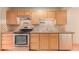 The kitchen features stainless steel appliances, light wood cabinets, and sleek countertops at 3780 E 117Th Ave, Thornton, CO 80233