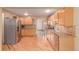 Open kitchen with stainless steel appliances, wood cabinets, and hardwood floors at 3780 E 117Th Ave, Thornton, CO 80233