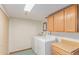 Functional laundry room with modern washer and dryer, storage, and ample counter space at 3780 E 117Th Ave, Thornton, CO 80233