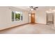 Bright living room featuring neutral carpeting, a large window, and a ceiling fan at 3780 E 117Th Ave, Thornton, CO 80233